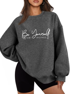 Detail of grey crewneck sweatshirt featuring white Be Yourself slogan print