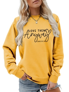 Close-up of mustard yellow sweatshirt featuring Luke 23:34 scripture text detail