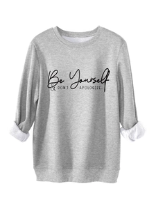 Detail of light grey sweatshirt featuring fleece lining and Be Yourself printed text