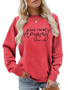 Close-up of red sweatshirt with black Love Them Anyway text and Luke 23:34 bible verse