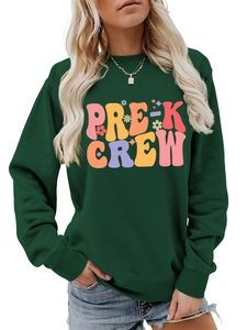 Close-up of Pre-K Crew colorful graphic print on a dark green crewneck sweatshirt