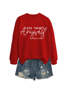 Detail of red crewneck sweatshirt with Love Them Anyway print and distressed denim shorts