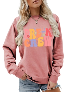 Detail of a dusty rose crewneck sweatshirt with Pre-K Crew colorful graphic print