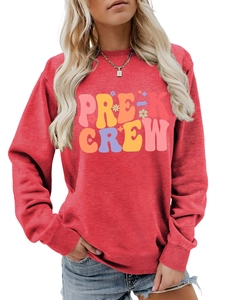 Detail of red crewneck sweatshirt featuring colorful PRE-K CREW rainbow graphic print