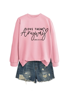 Detail view of pink sweatshirt with LOVE THEM anyway print and ripped denim shorts