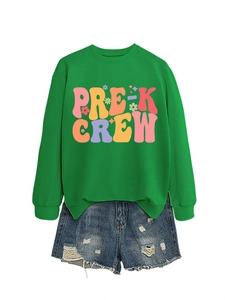 Detail of Pre-K Crew graphic print on grass green crewneck sweatshirt and denim shorts