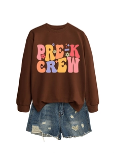 Detail of Pre-K Crew brown sweatshirt featuring colorful retro typography and denim shorts