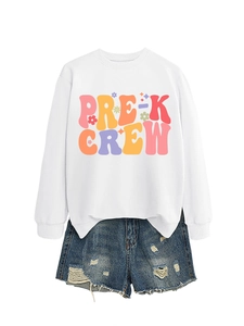 Flat lay of Pre-K Crew white sweatshirt paired with distressed blue denim shorts