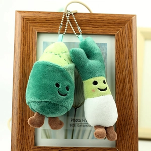 Close-up of cute vegetable plush keychain with smiling face and green fabric detail