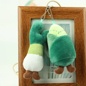 Detail of plush vegetable keychains featuring scalloped onion and cabbage with metal chains