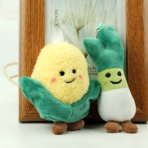 Detail of plush corn and green onion pendants with soft embroidery and metal chains