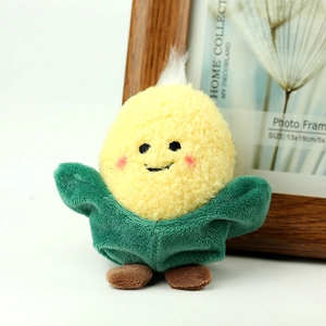 Macro shot of cute mini corn plush toy with yellow textured fabric and smiling face