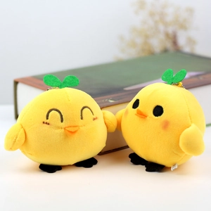 Close-up of small yellow chick plush keychains with green sprouts and metal bead chains