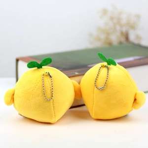 Detail of soft yellow plush lemon charms with green leaves and silver metal bead chains