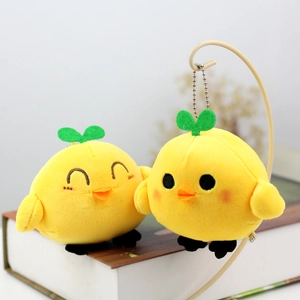 Close-up of cute plush yellow chick keychains with green sprouts and metal bead chains