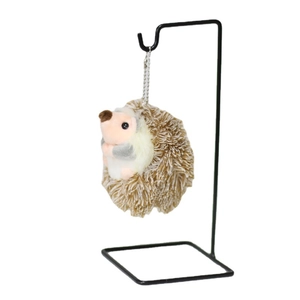 Cute brown hedgehog plush keychain on a metal stand for backpack and gift decoration