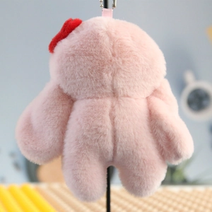 Detailed back view of pink plush bunny pendant with red bow and metallic bead chain