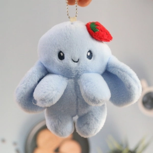 Cute light blue plush rabbit keychain with long ears and red strawberry accessory