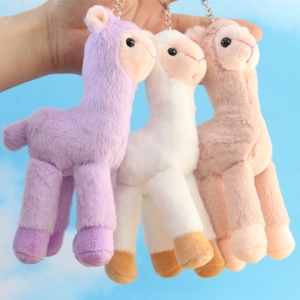 Three plush alpaca keychains in purple, white and khaki for bags and accessories