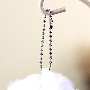 Close-up of white plush lamb charm with a silver bead chain for keychains and bags