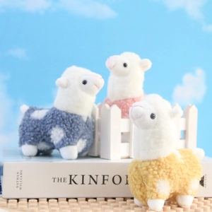 Three colorful plush alpaca pendants in blue, pink, and yellow with soft curly fur texture