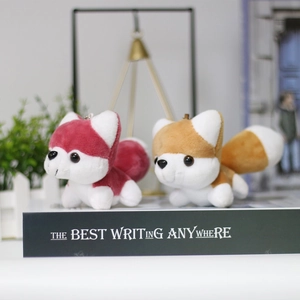 Close-up of cute plush husky puppy keychains in red and brown on decorative boxes