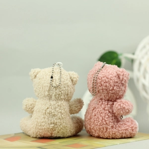 Detail of pink and cream mini teddy bear plush keychains with lamb wool texture