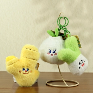 Detailed view of ginger, garlic and scallion plush keychains with embroidered faces
