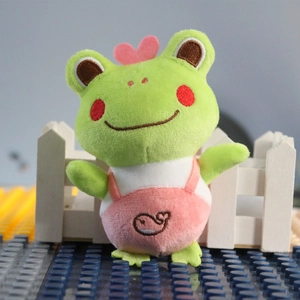 Cute green long-legged frog plush keychain with pink overalls and whale embroidery