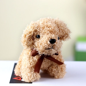 Macro detail of curly faux fur texture and brown bow on teddy dog plush toy