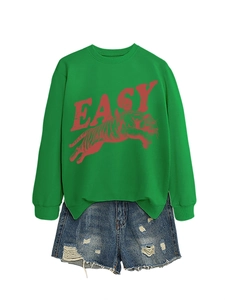 Detail of green long-sleeved sweatshirt with red EASY Tiger print and denim shorts