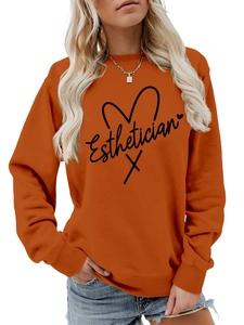 Detail of ribbed neckline and Esthetician print on orange crewneck sweatshirt
