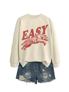 Detail of round neck sweatshirt with tiger print and side slit hem on white background