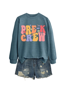 Close-up of Pre-K Crew long sleeve sweatshirt paired with distressed denim shorts