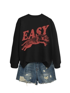 Flat lay of black tiger print sweatshirt with distressed EASY text and denim shorts