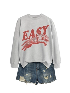 Detail of grey crewneck sweatshirt with red tiger print and distressed denim shorts