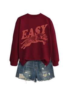 Close-up of vintage tiger print and EASY letters on burgundy crewneck sweatshirt fabric