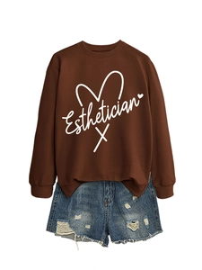Flat lay of a coffee-colored sweatshirt with Esthetician text and denim shorts