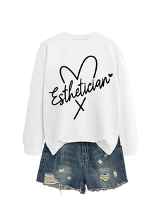 Close-up of white esthetician sweatshirt with heart print and ripped denim shorts