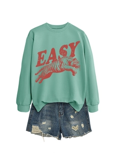 Detail of mint green sweatshirt with Easy tiger print and distressed denim shorts