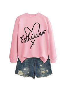 Detailed close-up of pink Esthetician sweatshirt with heart line graphic and denim shorts