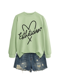 Detail of light green Esthetician sweatshirt with side slit and distressed denim shorts