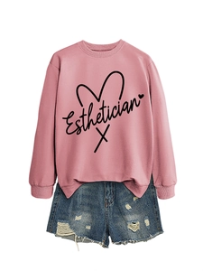 Pink crewneck sweatshirt with Esthetician lettering and heart graphic with denim shorts