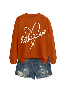 Detail of the white Esthetician script and heart line graphic on a brown sweatshirt