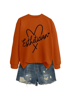 Detail of orange Esthetician sweatshirt with line heart and distressed denim shorts