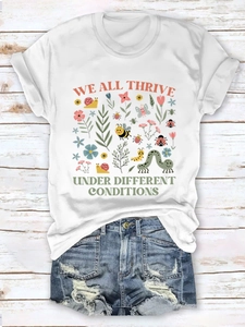 Macro shot of colorful floral garden print and slogan on a white summer t-shirt
