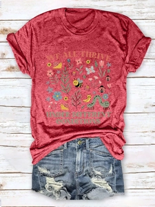 Flat lay of heather red t-shirt with nature print and distressed denim shorts