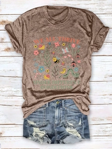 Flat lay of vintage wash t-shirt with nature print and distressed denim shorts