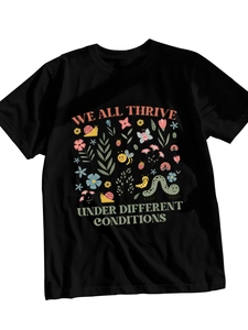 Close-up of colorful cartoon insect and floral print on black cotton t-shirt fabric