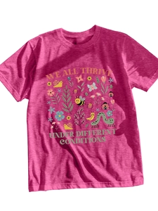 Close-up of magenta t-shirt with insects, flowers, and 'We all thrive' text detail